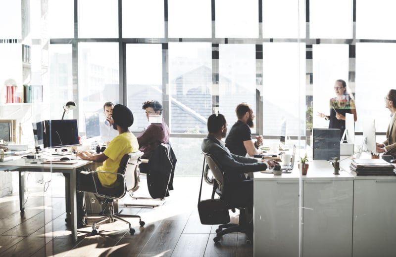 people working at their desks in an open plan office (1)