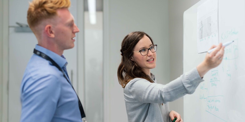 Female employee training male colleague