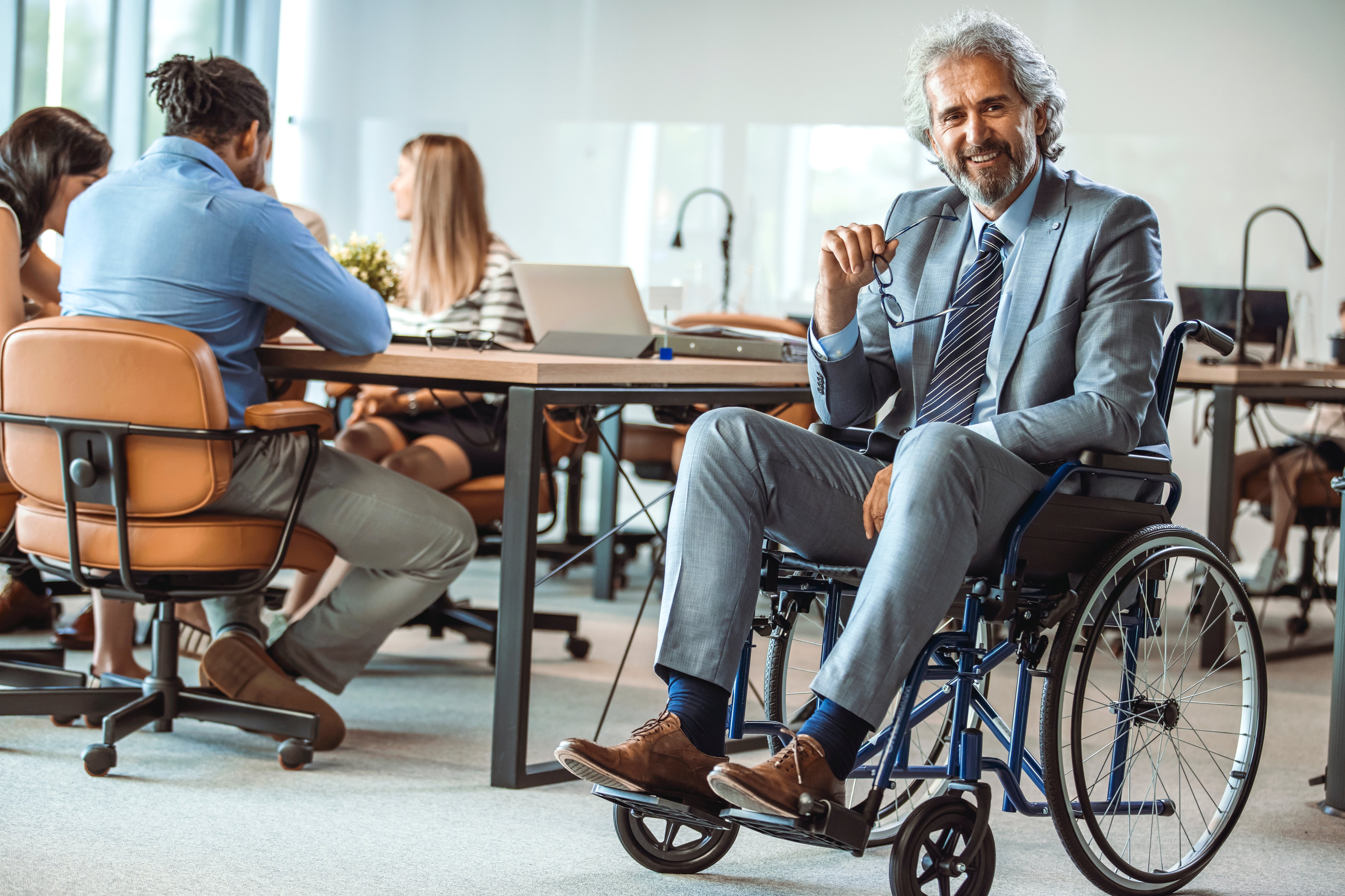 An employee smiles in an office in Germany