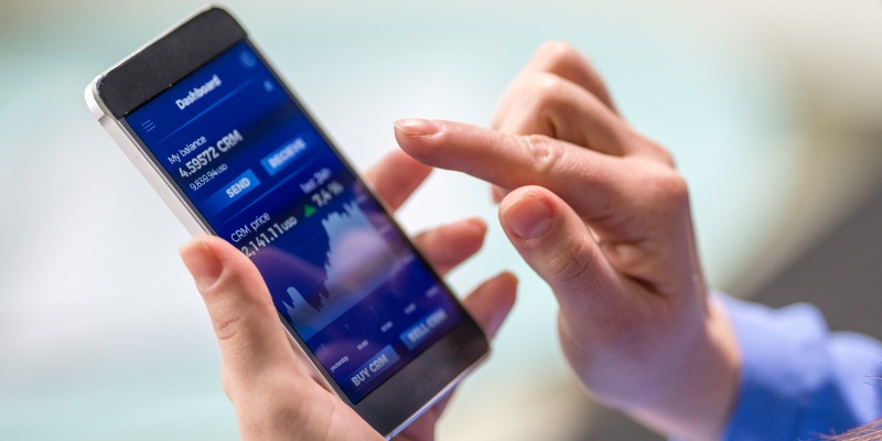 woman-buying-cryptocurrency-through-mobile-phone-app-picture-id1054923550