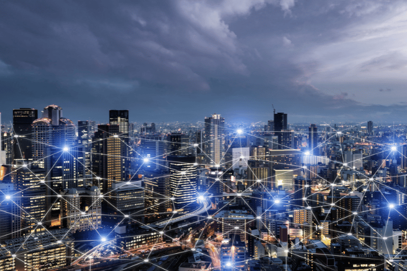 Bird's eye-view of a cityscape with bright connecting lines