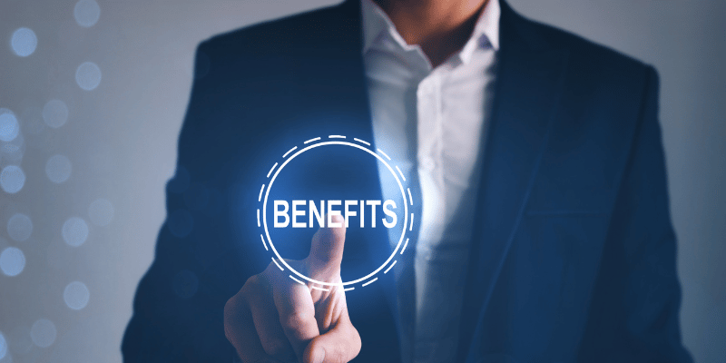 Man in business attire pointing at a holograph containing the word "benefits"