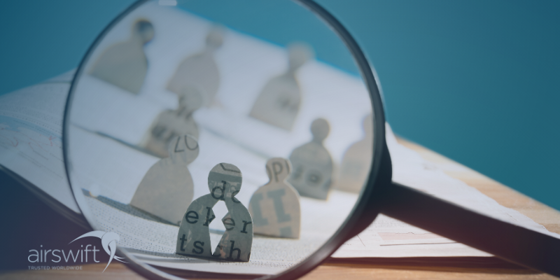 A magnifying glass over candidates profiles