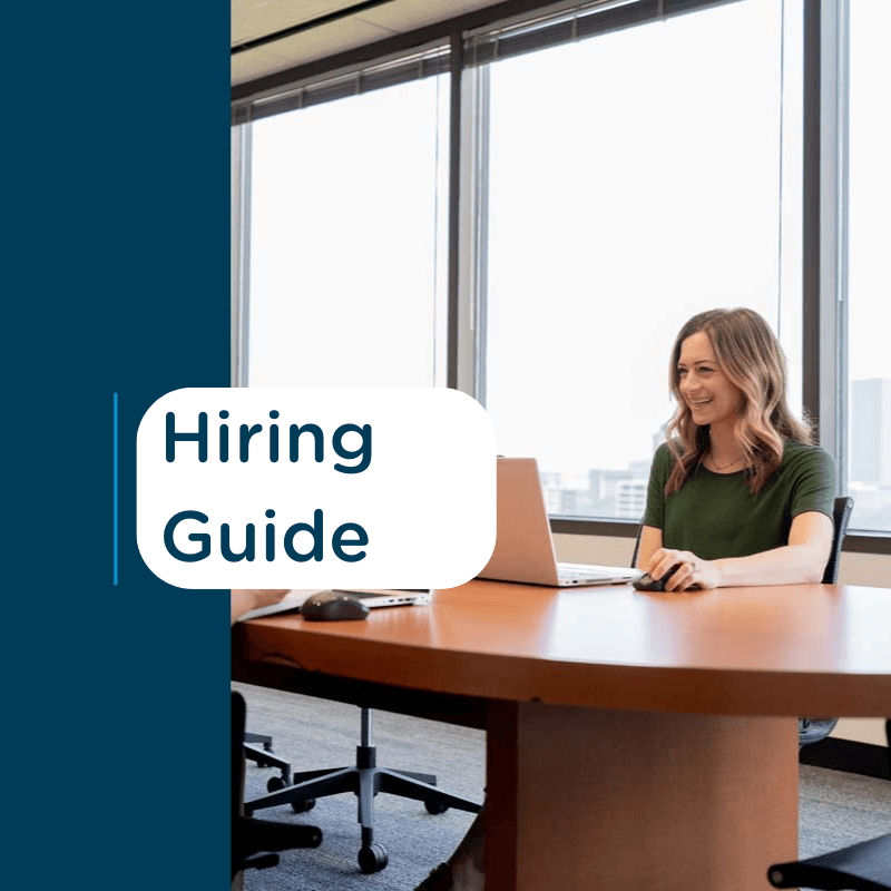 Woman in green shirt smiling during an interview with text 'Hiring Guide' on a blue background.